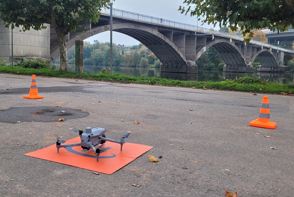 Drohne mit Landeplattform nahe Brücke